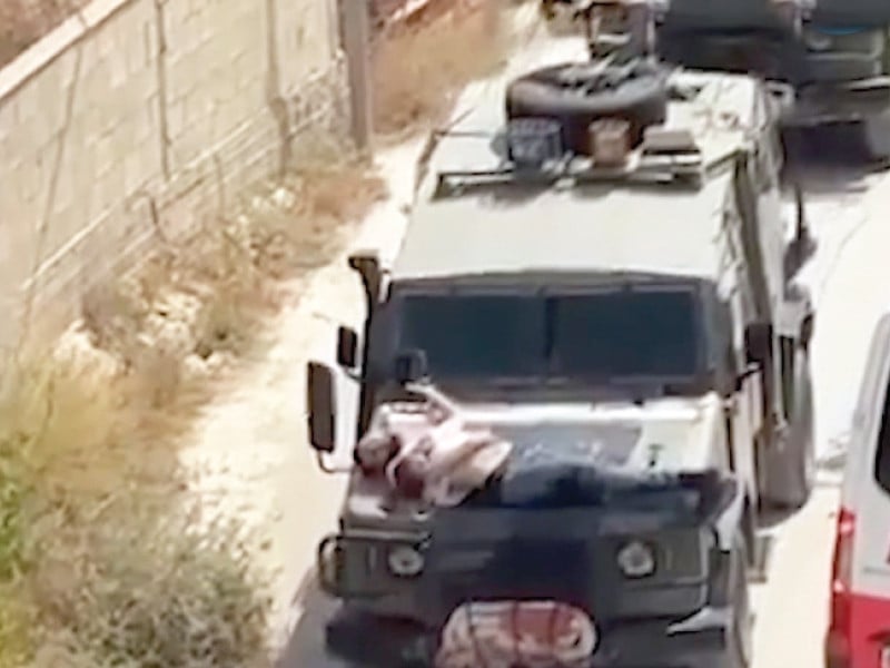 israeli army troops strap palestinian on military jeep during a raid in jenin in this screengrab from a video in the israeli occupied west bank photo reuters