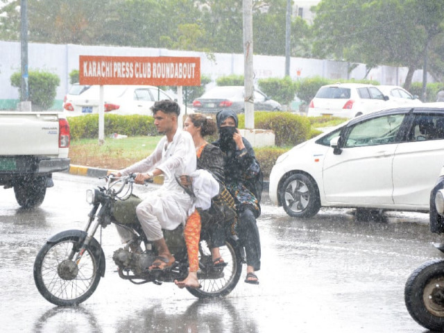 three people on a bike pass through a busy intersection in saddar during light rain on thursday photo jalal qureshi express three people on a bike pass through a busy intersection in saddar during light rain on thursday photo jalal qureshi express