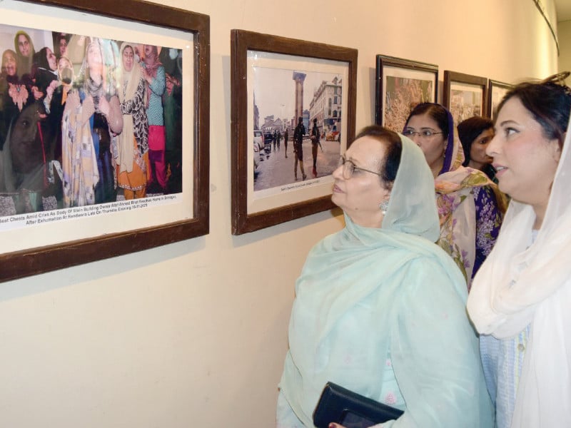 visitors observe poignant photographs from occupied kashmir capturing the harsh realities of indian oppression during an exhibit held on youm e istehsaal in punjab arts council rawalpindi photo express