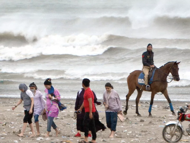 horse mounted police tell people to move away from the sea view beach on friday due to threat of being washed away in high tides caused by cyclone asna photo jalal qureshi express horse mounted police tell people to move away from the sea view beach on friday due to threat of being washed away in high tides caused by cyclone asna photo jalal qureshi express
