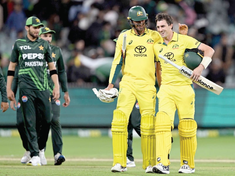 australian skipper pat cummins r is congratulated by teammate mitchell starc after hitting the winning runs as pak players watch in the first odi photo afp