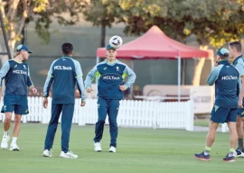 australia s players warm up during a practice sesson in dubai on monday ahead of the icc champions trophy semi final match against india photo afp