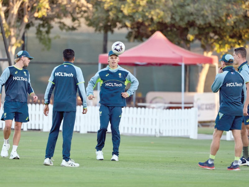 australia s players warm up during a practice sesson in dubai on monday ahead of the icc champions trophy semi final match against india photo afp