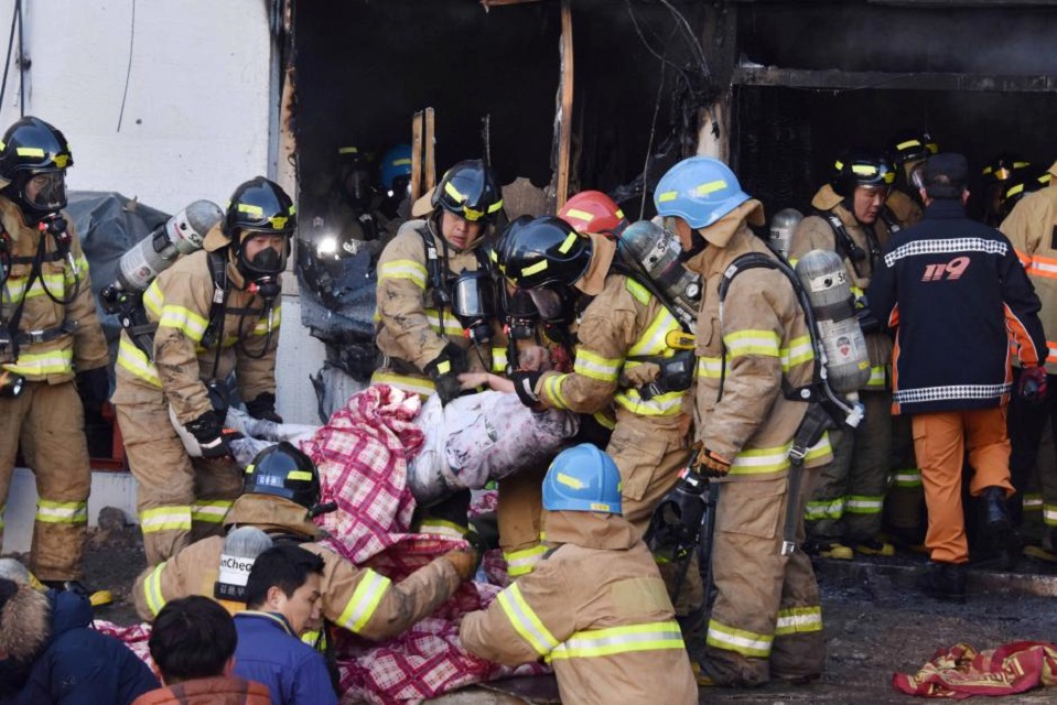 firefighters rescue a patient from a hospital in miryang south korea flames and toxic smoke swept through the hospital on friday killing at least 37 people and injuring more than 140 photo reuters