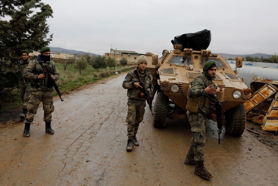 members of turkey backed free syrian army police forces secure the road as they escort a convoy near azaz syria january 26 2018 photo reuters