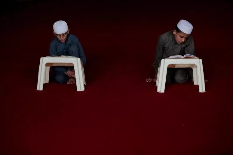 students read the holy book at a madrassa photo reuters students read the holy book at a madrassa photo reuters