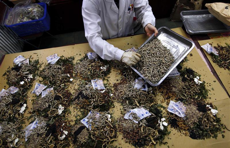 a worker prepares traditional chinese herbal medicines at beijing 039 s capital medical university traditional chinese medicine hospital photo reuters