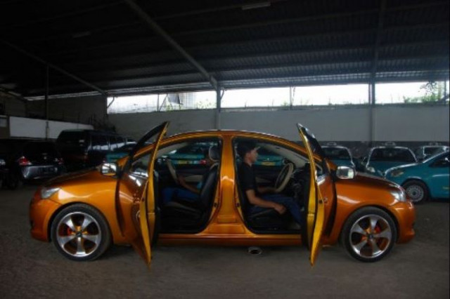 the double ended car was built by roni gunawan by welding together the front halves of two orange toyota limos photo afp the double ended car was built by roni gunawan by welding together the front halves of two orange toyota limos photo afp