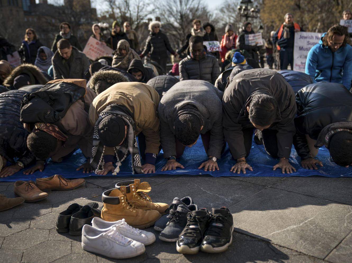 muslims pray following a protest to the mark the one year anniversary of the trump administration 039 s executive order banning travel into the united states from several muslim majority countries in washington square park photo online