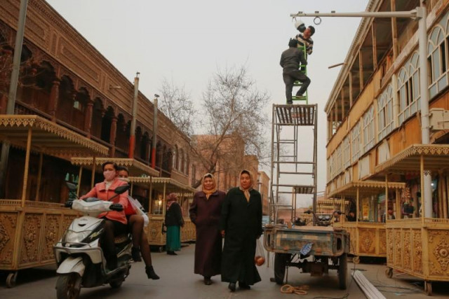 men install a cctv camera in a shopping street in the old town of kashgar xinjiang uighur autonomous region china photo reuters men install a cctv camera in a shopping street in the old town of kashgar xinjiang uighur autonomous region china photo reuters
