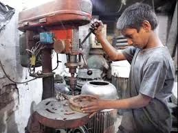 a child labourer operates a drill machine at a workshop in lahore photo app a child labourer operates a drill machine at a workshop in lahore photo app