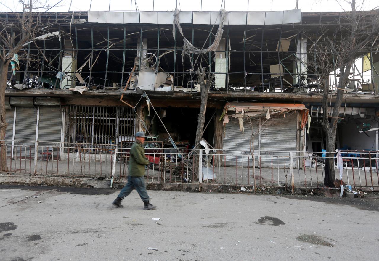 afghan policemen inspect the site of a bomb attack in kabul photo reuters