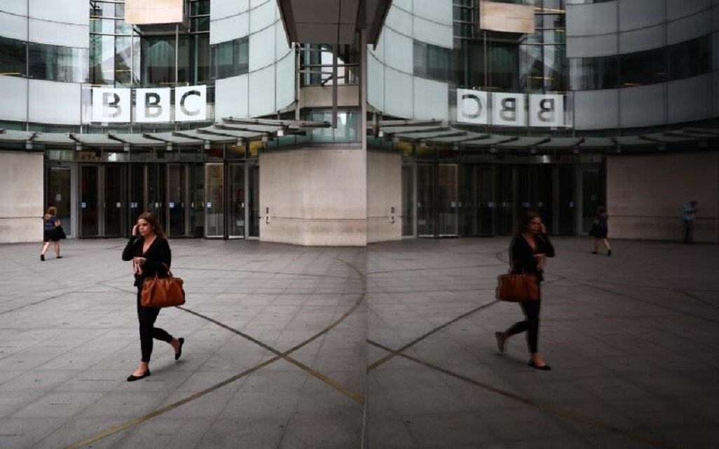 a woman is reflected as she passes the bbc 039 s broadcasting house in london britain july 19 2017 photo reuters