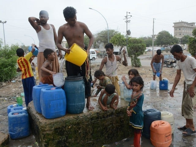 people filling their containers with water near korangi due to the shortage of water photo file people filling their containers with water near korangi due to the shortage of water photo file