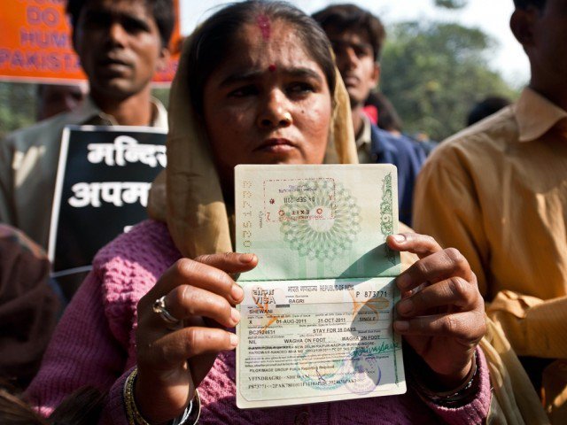 a hindu refugee from pakistan shows her now expired indian visa page on her passport photo afp file