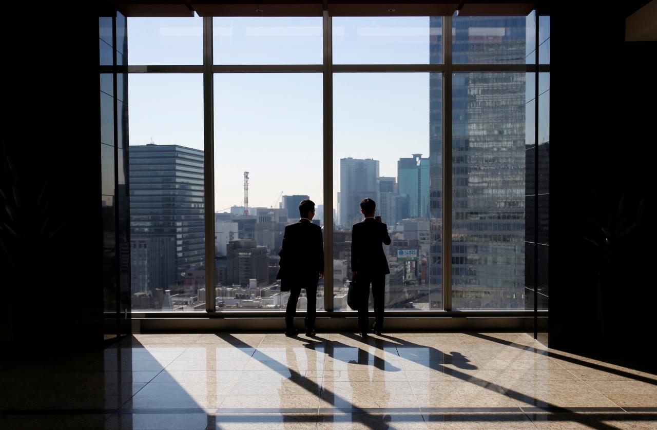 businessmen are seen inside a high rise office building photo reuters