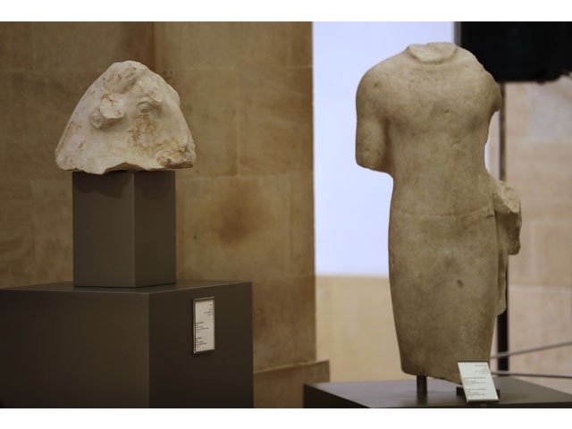 a picture taken on february 2 2018 shows a marble sculpture of a bull 039 s head l dating back to the 4th century bc next to another of a standing male figure dressed in a tight fitting chiton a sewn garment holding a calf in the left hand dating back to the 6th century bc both part of a collection of repatriated artefacts on display during a ceremony at beirut national museum in the lebanese capital photo afp