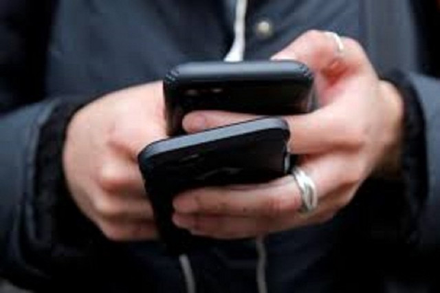 a woman uses her cell phones in manhattan new york u s january 30 2018 photo reuters a woman uses her cell phones in manhattan new york u s january 30 2018 photo reuters