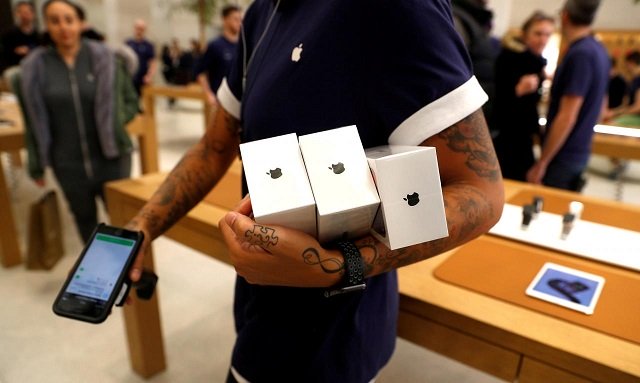 an apple store staff shows apple 039 s new iphones x after they go on sale at the apple store in regents street london britain november 3 2017 photo reuters