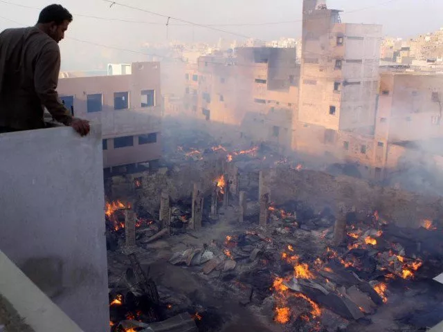 the timber market near old haji camp in karachi smolders on sunday morning where as 250 shops and 50 warehouses were gutted photo inp the timber market near old haji camp in karachi smolders on sunday morning where as 250 shops and 50 warehouses were gutted photo inp