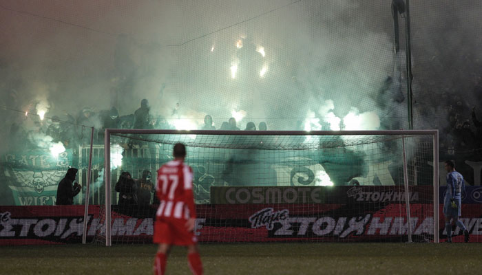 olympiakos fans raid pitch after loss to athens in greek derby