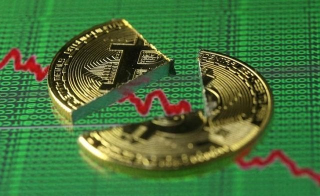 broken representation of the bitcoin virtual currency placed on a monitor that displays stock graph and binary codes are seen in this illustration picture december 21 2017 photo reuters broken representation of the bitcoin virtual currency placed on a monitor that displays stock graph and binary codes are seen in this illustration picture december 21 2017 photo reuters