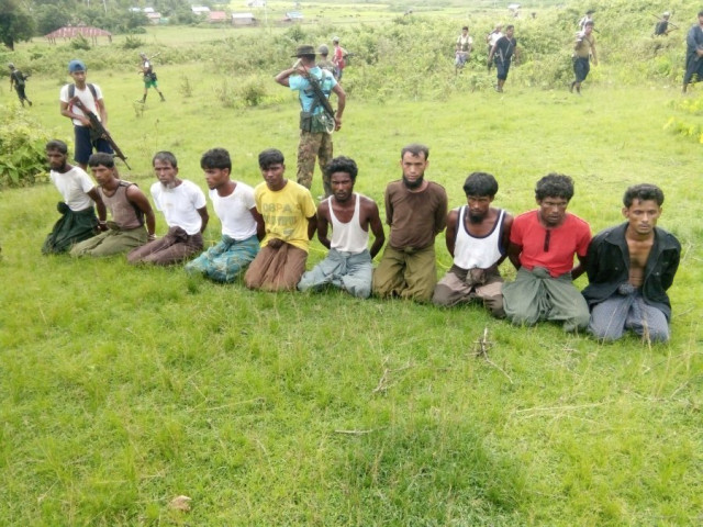ten rohingya muslim men with their hands bound kneel as members of the myanmar security forces stand guard in inn din village photo reuters ten rohingya muslim men with their hands bound kneel as members of the myanmar security forces stand guard in inn din village photo reuters