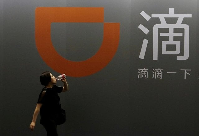 a woman walks past didi chuxing 039 s booth at the global mobile internet conference gmic 2017 in beijing china april 28 2017 photo reuters a woman walks past didi chuxing 039 s booth at the global mobile internet conference gmic 2017 in beijing china april 28 2017 photo reuters