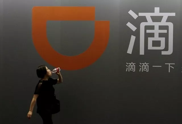 a woman walks past didi chuxing 039 s booth at the global mobile internet conference gmic 2017 in beijing china april 28 2017 photo reuters a woman walks past didi chuxing 039 s booth at the global mobile internet conference gmic 2017 in beijing china april 28 2017 photo reuters