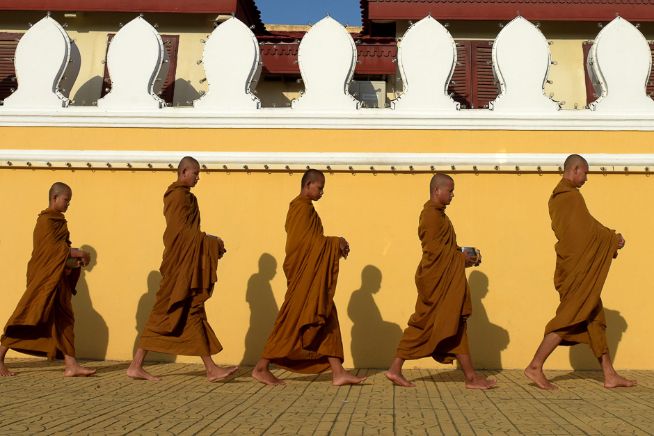 buddhist monks walk in front of the royal palace in phnom penh photo afp file