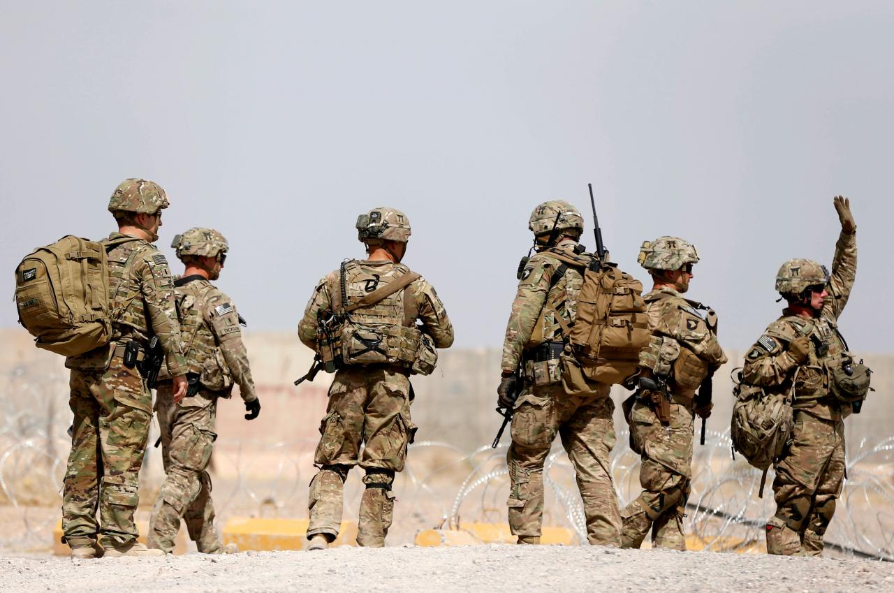 us troops walk outside their base in uruzgan province afghanistan photo reuters