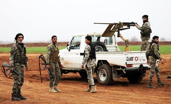 turkey backed free syrian army fighters stand around a pickup truck with a mounted weapon in the town of marea in northern aleppo countryside syria on saturday photo reuters