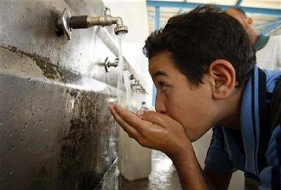 a palestinian youth drinks water from a public tap in khan younis in the southern gaza strip photo reuters file