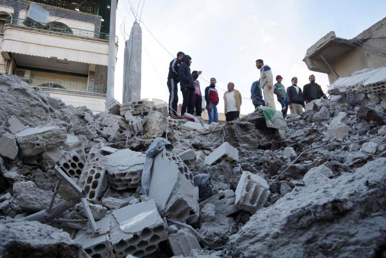 residents inspect a damaged site from what activists said were airstrikes carried out by the russian air force in nawa city deraa syria photo reuters