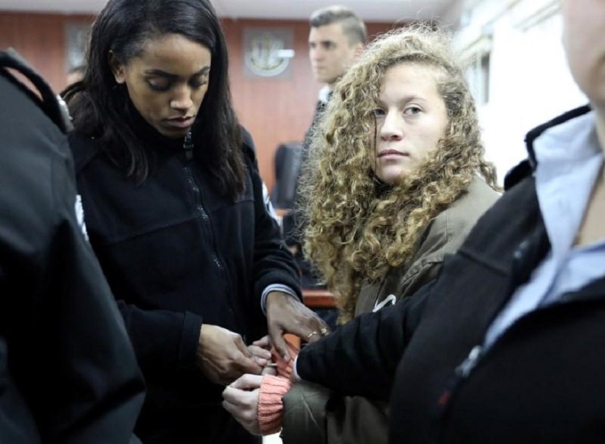 palestinian teen ahed tamimi r enters a military courtroom escorted by israeli prison service personnel at ofer prison near the west bank city of ramallah january 1 2018 photo reuters