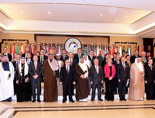 kuwaiti foreign minister sheikh sabah al khaled al sabah c stands next to iraq prime minister haider al abadi eu foreign policy chief frederica mogherini un secretary general antonio guterres as they pose with other officials for a group photo on the second day of an international conference for reconstruction of iraq in kuwait city on february 14 2018 photo afp