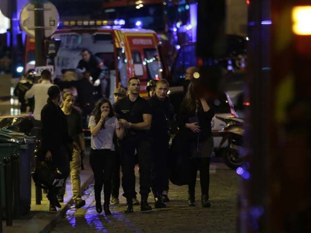 people are evacuated following an attack at the bataclan concert venue in paris on november 13 2015 at least 18 people were killed in multiple attacks in paris friday including one near the stade de france sports stadium photo afp
