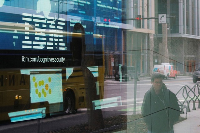 pedestrians pass a video advertisement for ibm at their office in cambridge massachusetts us january 16 2018 photo reuters