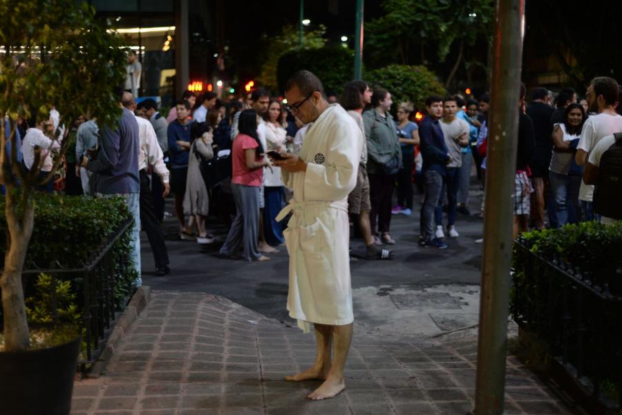 people gather on a street in downtown mexico city during an earthquake photo afp
