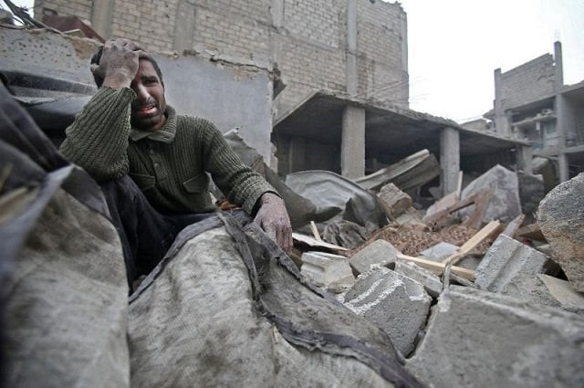 a syrian mourns in the rubble of his home photo afp a syrian mourns in the rubble of his home photo afp