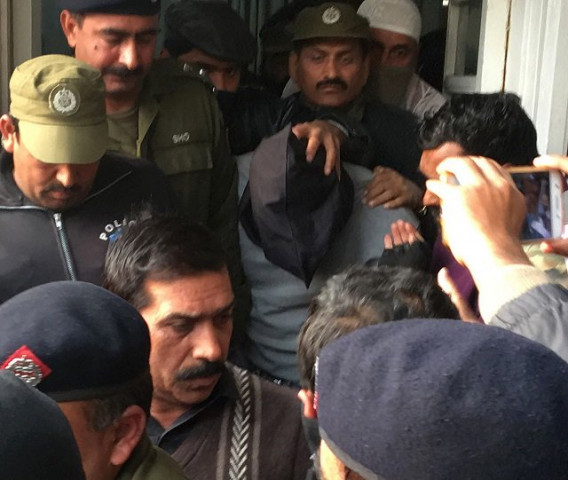 policemen escort the suspect accused of raping and murdering a young girl as they leave an anti terrorist court in lahore on january 24 2018 photo afp policemen escort the suspect accused of raping and murdering a young girl as they leave an anti terrorist court in lahore on january 24 2018 photo afp