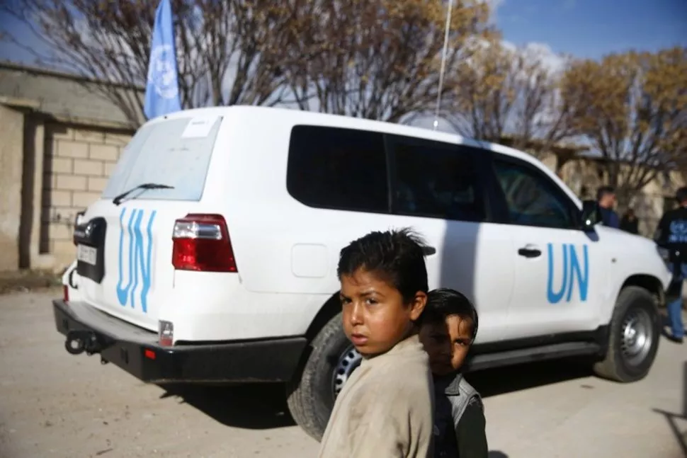 children stand near a un vehicle in the village of otaya eastern ghouta in damascus syria photo reuters children stand near a un vehicle in the village of otaya eastern ghouta in damascus syria photo reuters