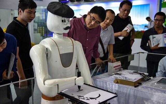 people watch a robot painting demonstration during the 19th china hi tech fair in shenzhen south china 039 s guangdong province november 16 2017 photo xinhuanet