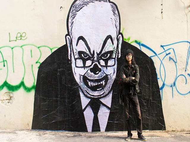 malaysian artist fahmi reza with one of the versions of his caricatures of prime minister najib razak looking like a clown photo courtesy facebook fahmi reza malaysian artist fahmi reza with one of the versions of his caricatures of prime minister najib razak looking like a clown photo courtesy facebook fahmi reza