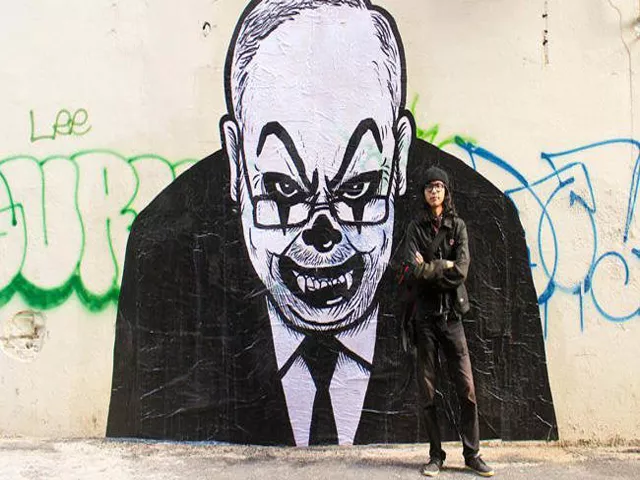 malaysian artist fahmi reza with one of the versions of his caricatures of prime minister najib razak looking like a clown photo courtesy facebook fahmi reza malaysian artist fahmi reza with one of the versions of his caricatures of prime minister najib razak looking like a clown photo courtesy facebook fahmi reza