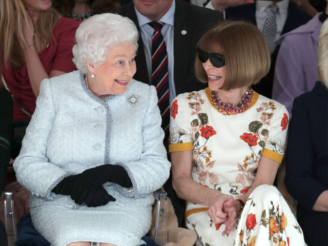 britain s queen elizabeth ii sits next to vogue editor in chief anna wintour as they view richard quinn 039 s runway show before presenting him with the inaugural queen elizabeth ii award for british design as she visits london fashion week in london britain february 20 2018 reuters yui mok pool