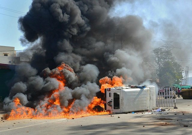 a police van set on fire by an angry mob after a speeding truck rammed into a house and a shop in barela jabalpur photo courtesy of press trust of india