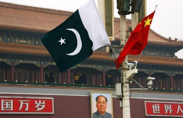 a pakistan national flag flies alongside a chinese national flag in front of the portrait of chairman mao zedong on beijing 039 s tiananmen square photo reuters