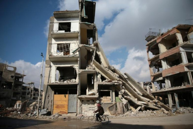 a man rides a bicycle near damaged buildings in the rebel held besieged city of douma in the eastern damascus suburb of ghouta syria december 30 2016 photo reuters a man rides a bicycle near damaged buildings in the rebel held besieged city of douma in the eastern damascus suburb of ghouta syria december 30 2016 photo reuters