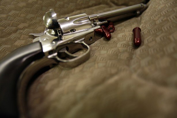 a revolver and dummy bullets are displayed on a case photo reuters